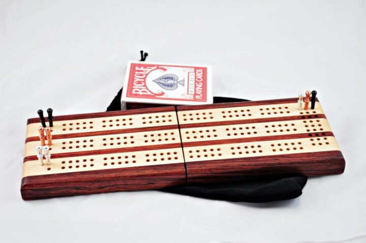 Bubinga and Maple 3 Player Travel Cribbage Board. laying flat and ready for play!
